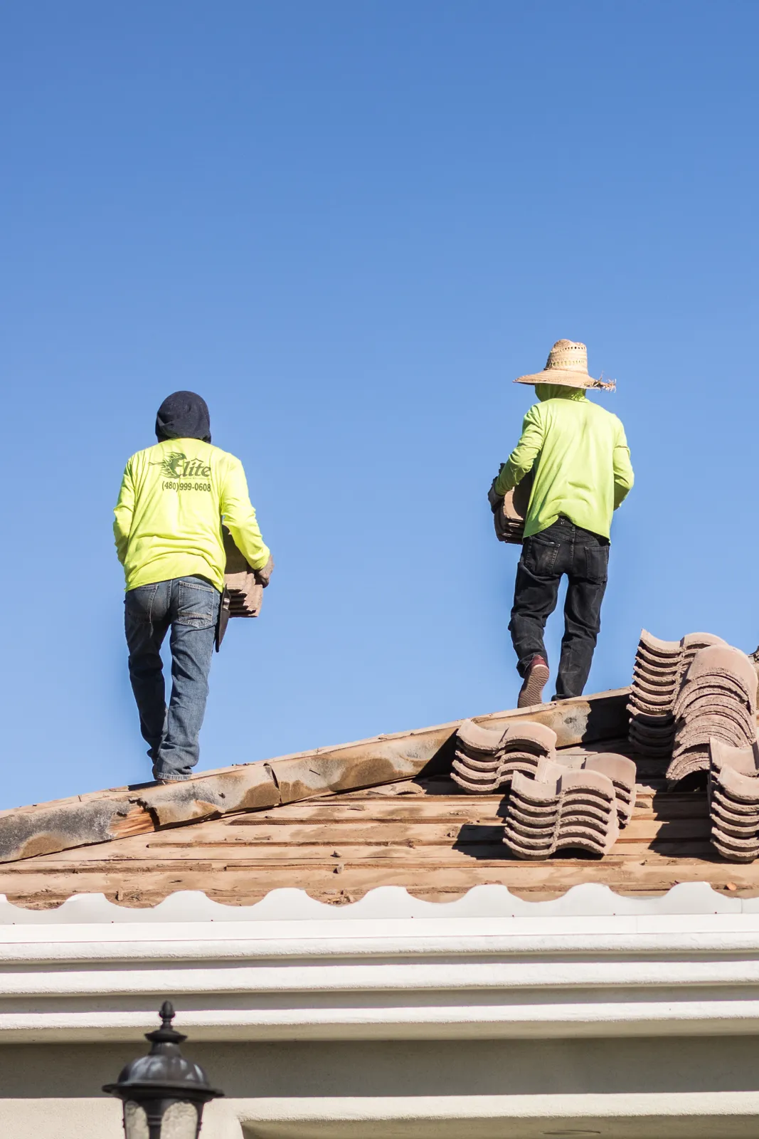 Elite Roofing and Remodeling crew working on a clay tile roof in Arizona