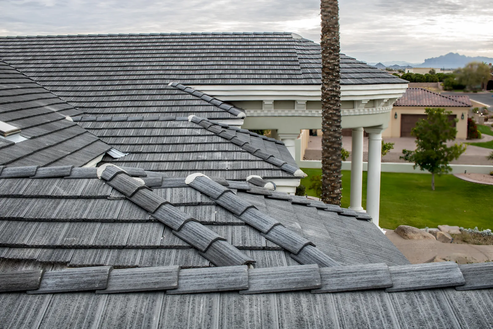 Repaired concrete tile roof with new ridge caps on a Phoenix-area home